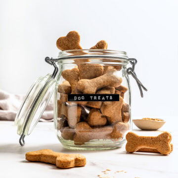 Homemade soft dog treats in labeled jar.