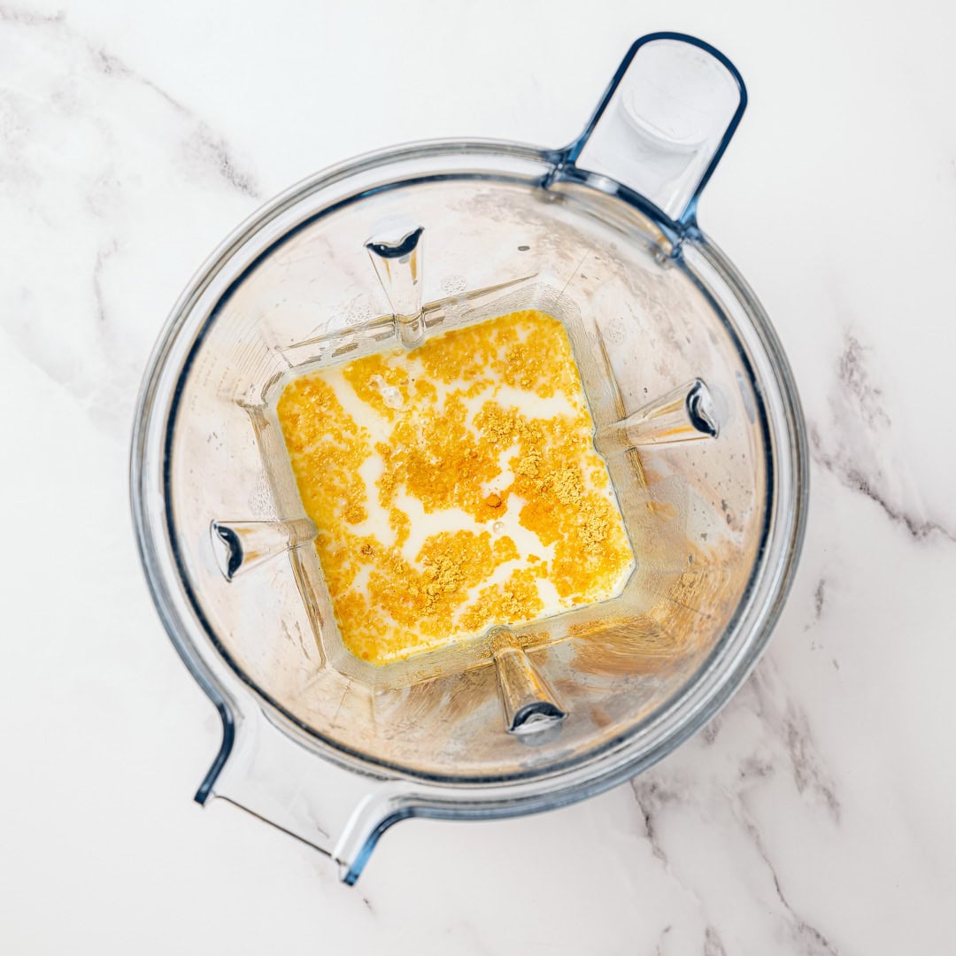 This homemade vegan butter melts, spreads and tastes like the real thing! Easy to make with everyday ingredients, you can even bake with it. Ingredients for vegan butter in blender before blending.