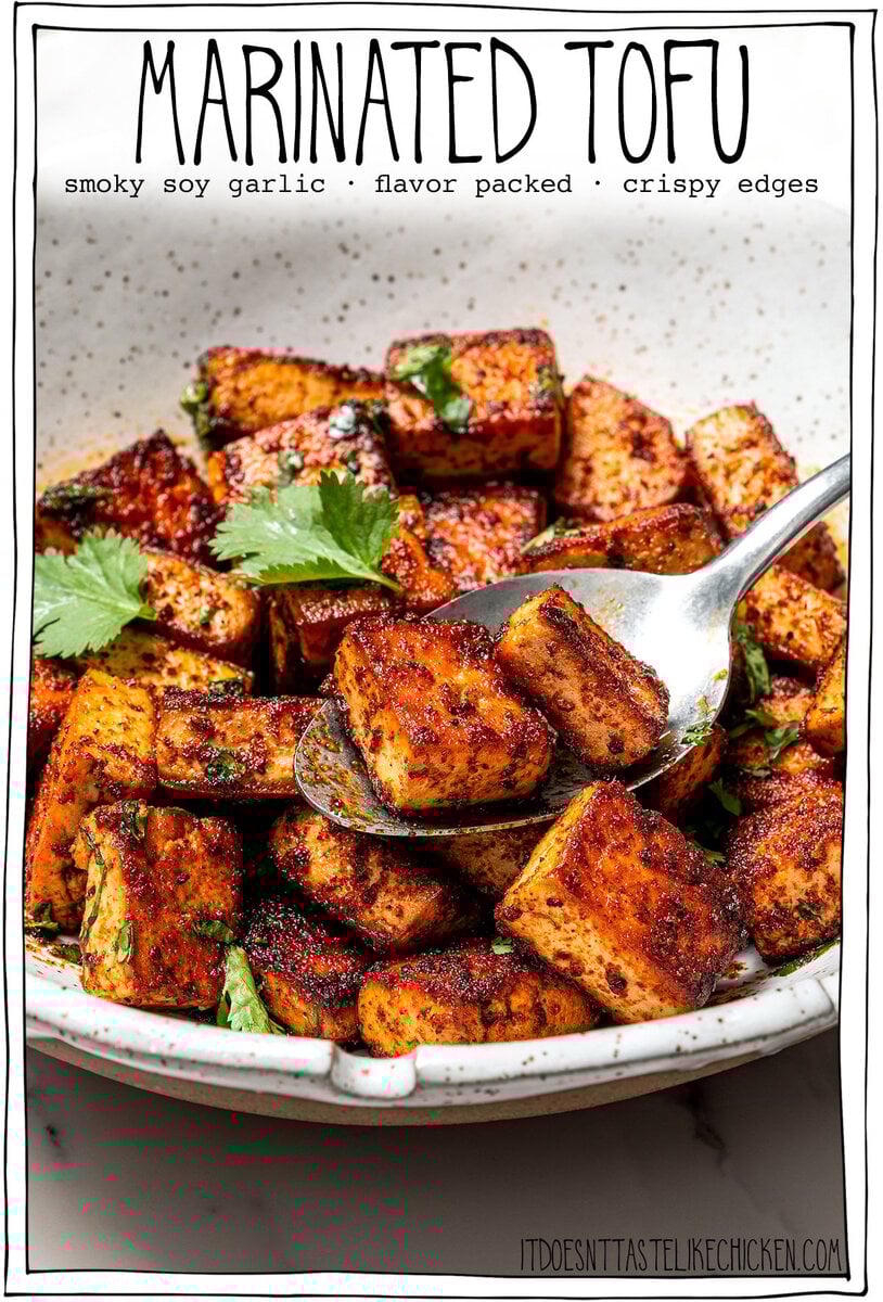 Spoon in bowl of marinated tofu.