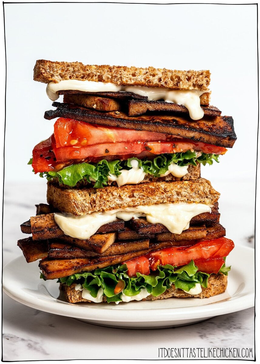 This vegan BLT is made with smoky plant-based bacon, juicy tomatoes, crisp lettuce, and creamy mayo. Easy, satisfying, and ready fast! Two vegan BLTs stacked on plate.