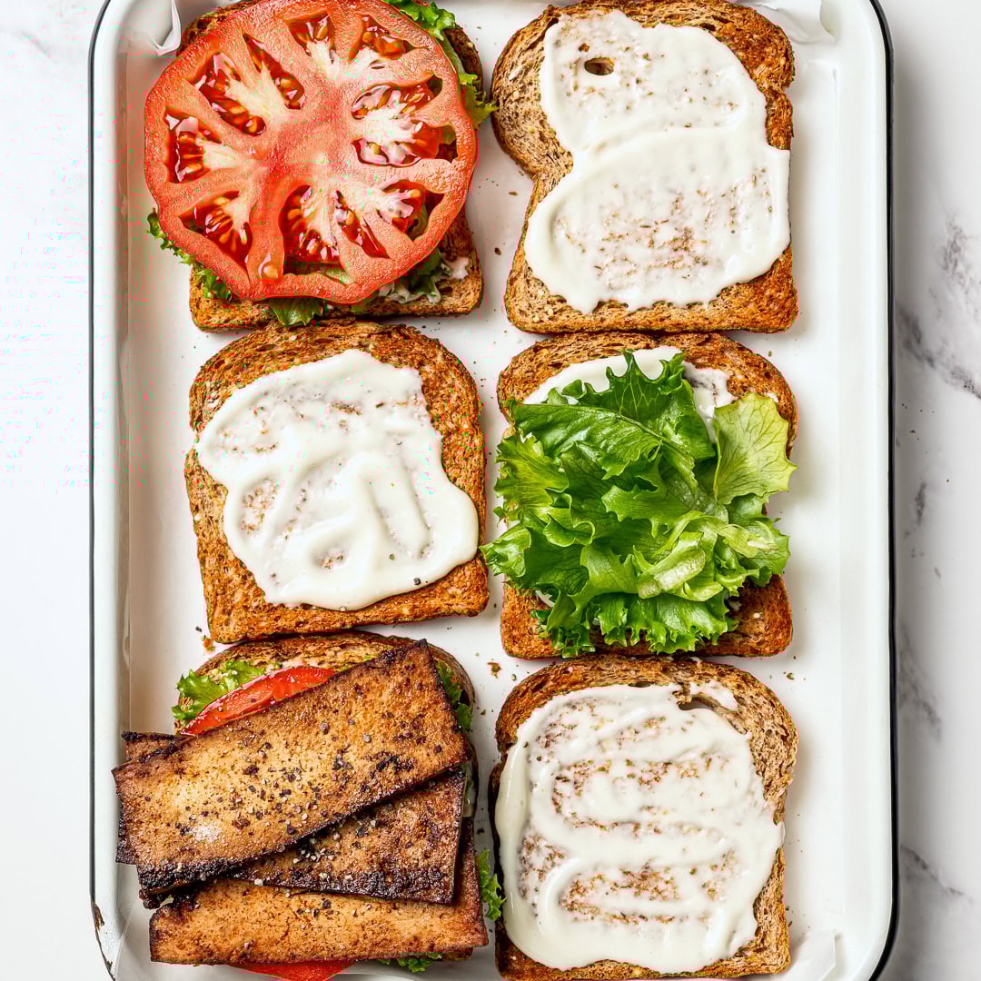 This vegan BLT is made with smoky plant-based bacon, juicy tomatoes, crisp lettuce, and creamy mayo. Easy, satisfying, and ready fast! Toasted bread layered with vegan mayo, lettuce, tomato, and vegan bacon.
