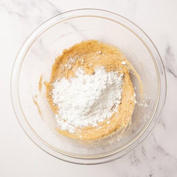 Dry ingredients added to bowl of wet ingredients for blondies.