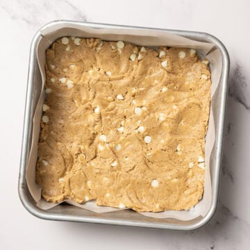 Blondie batter in parchment lined pan.