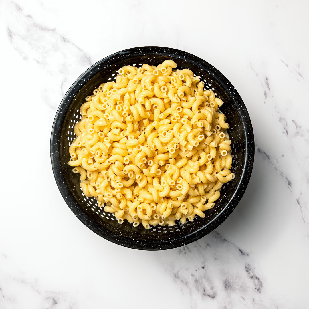 Elbow noodles in colander.