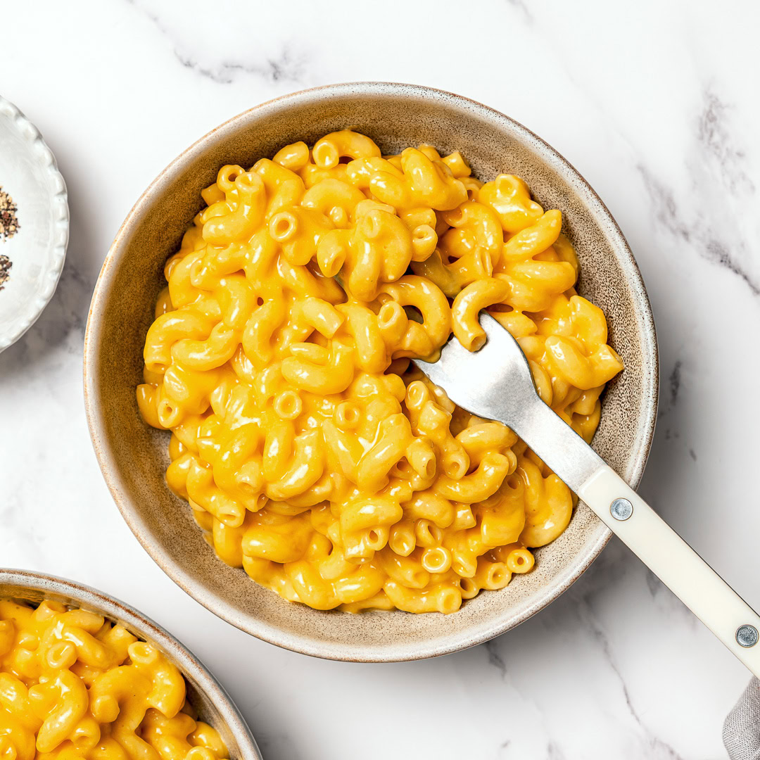 Overhead shot of bowl of mac and cheese with fork.