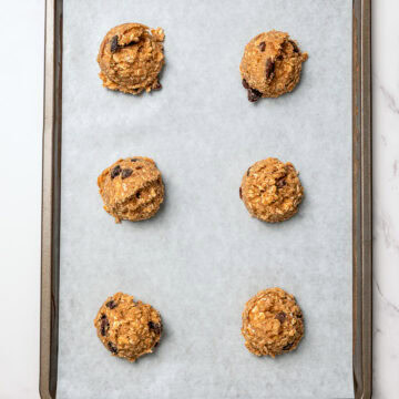 Vegan oatmeal raisin cookie dough on sheet pan.