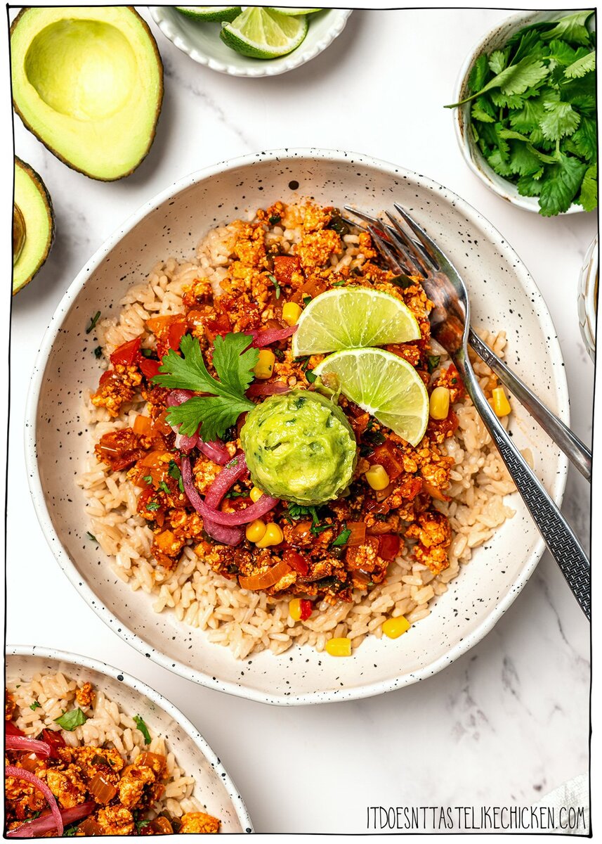 These smoky, saucy vegan sofritas are made in one pan with tofu, chipotle, and spices. Perfect for tacos, bowls, burritos, and meal prep! Burrito bowl with rice, sofritas, guacamole, pickled red onion, and lime wedges.
