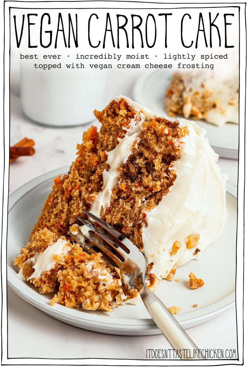 Fork cutting into a slice of vegan carrot cake with cream cheese frosting.