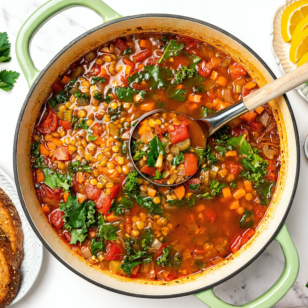 This easy lentil soup is a cozy one-pot recipe made with simple pantry ingredients! A hearty, healthy vegan meal perfect for meal prep. Ladle in pot of lentil soup.