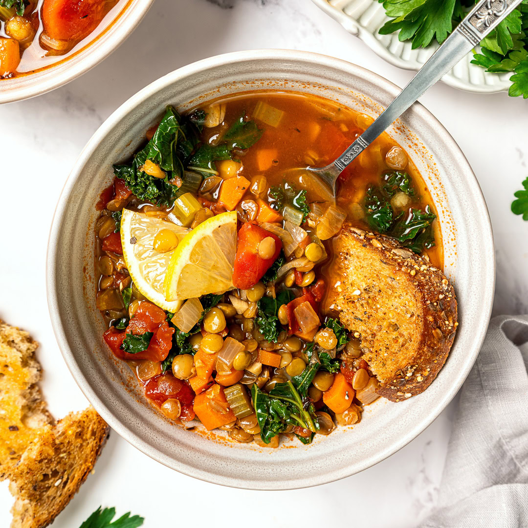 Bowl of easy lentil soup with spoon and crusty bread.