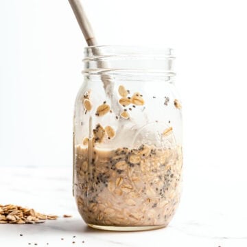 Spoon in jar of overnight oats with chia seeds.