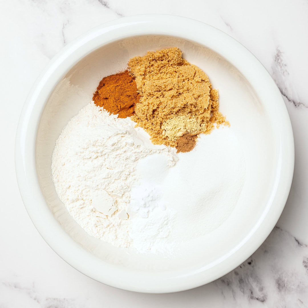 Dry ingredients for carrot cake in a mixing bowl.