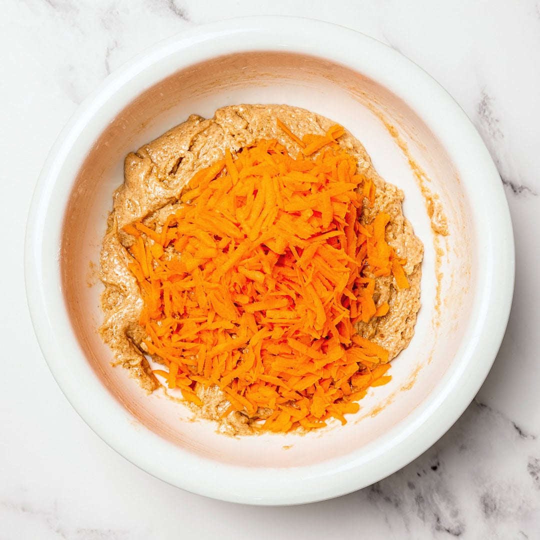Grated carrots added to batter for vegan carrot cake.