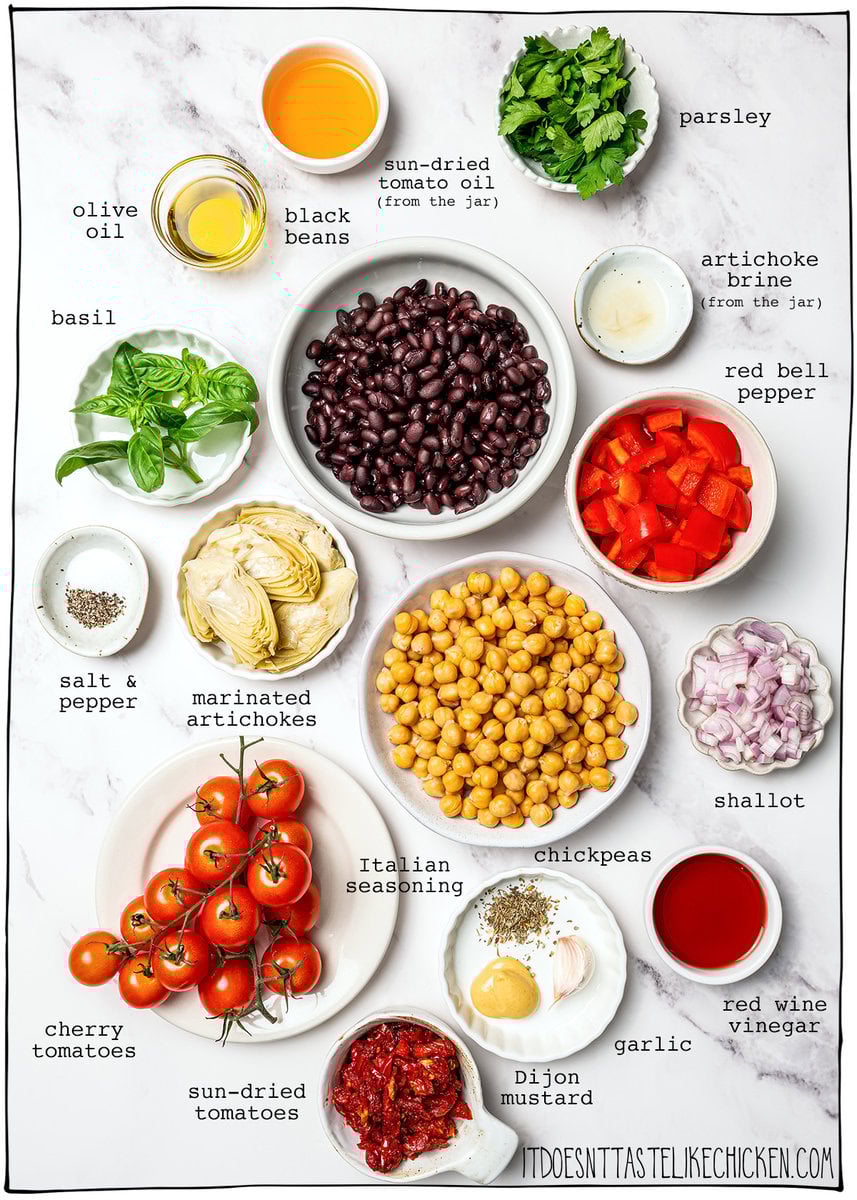 Dense bean salad packs hearty beans, crunchy veggies, and bold dressing into a satisfying make-ahead dish that stays tasty all week long! Ingredients for dense bean salad with labels.