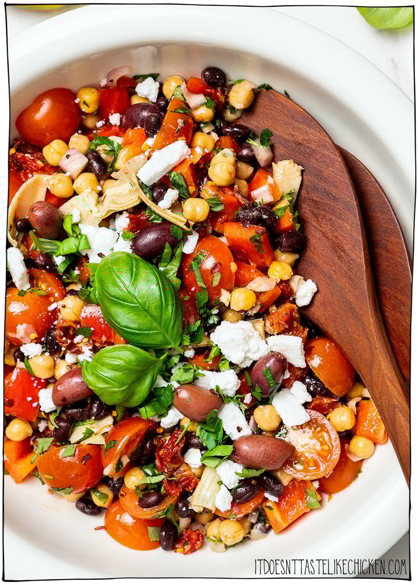 Dense bean salad packs hearty beans, crunchy veggies, and bold dressing into a satisfying make-ahead dish that stays tasty all week long! Bowl of vegan dense bean salad.