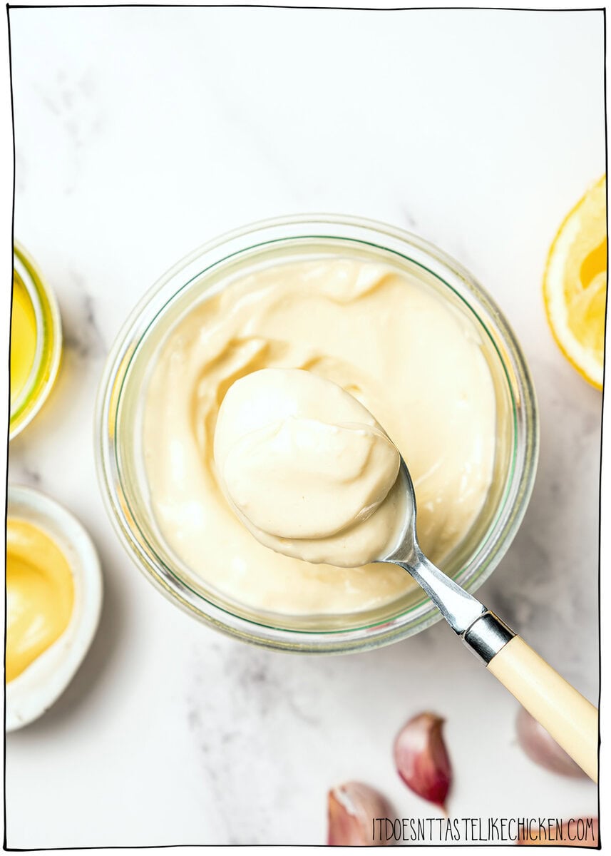 Creamy, garlicky, and full of bold flavor, this vegan garlic aioli is an easy recipe that instantly upgrades fries, sandwiches, and more! Spoonful of vegan garlic aioli set in jar.