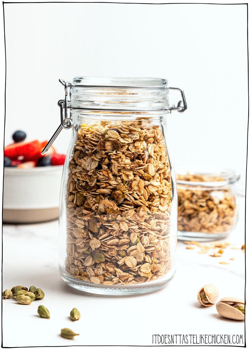 This pistachio cardamom granola is lightly sweet, perfectly crunchy, and infused with warm, aromatic cardamom. Easy 30 minute recipe! Jar of pistachio cardamom granola.