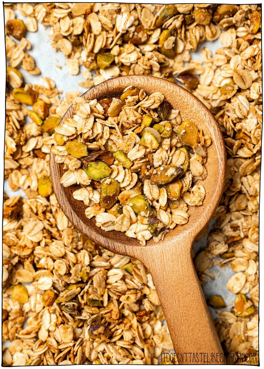 This pistachio cardamom granola is lightly sweet, perfectly crunchy, and infused with warm, aromatic cardamom. Easy 30 minute recipe! Pistachio cardamom granola in spoon.