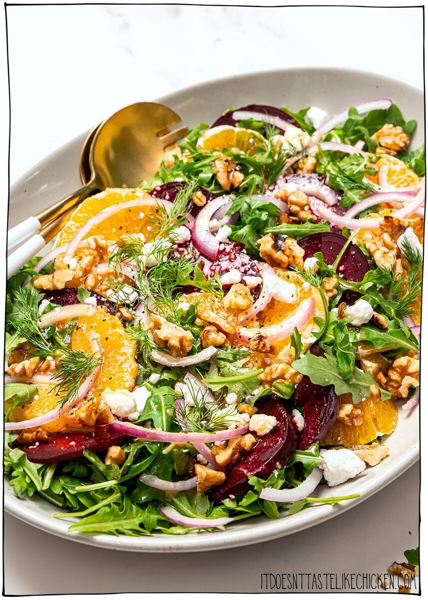 This roasted beet salad is fresh, vibrant and flavorful, with sweet roasted beets, juicy oranges and a tangy dressing. Elegant yet simple! Platter of roasted beet salad with oranges, red onion, greens, and walnuts.