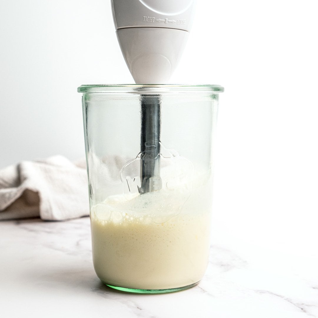 Creamy, garlicky, and full of bold flavor, this vegan garlic aioli is an easy recipe that instantly upgrades fries, sandwiches, and more! Immersion blender in jar of garlic aioli.