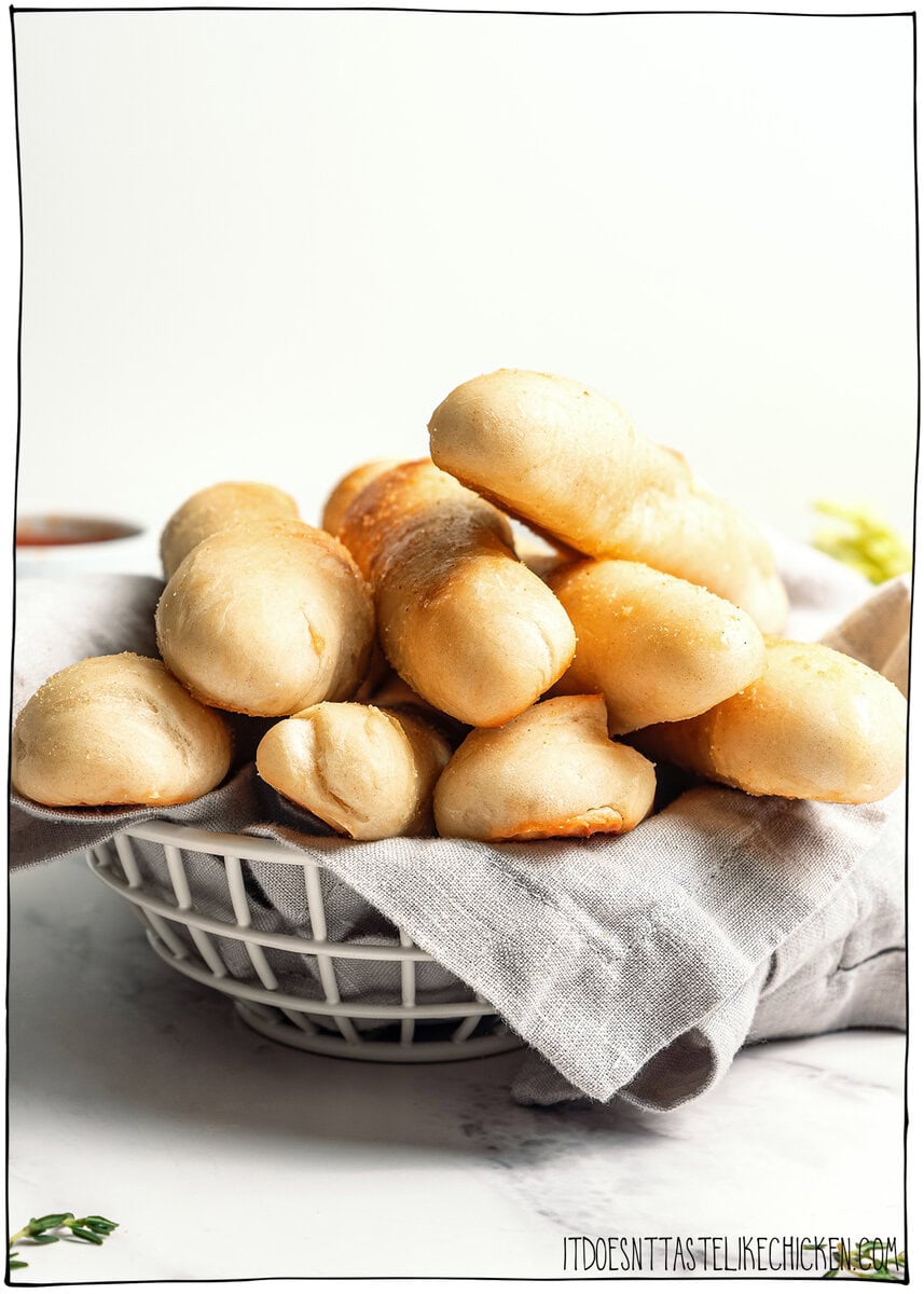 These vegan Olive Garden breadsticks are soft, fluffy, and brushed with buttery garlic salt, just like the restaurant. So irresistible! Basket of homemade vegan Olive Garden breadsticks.