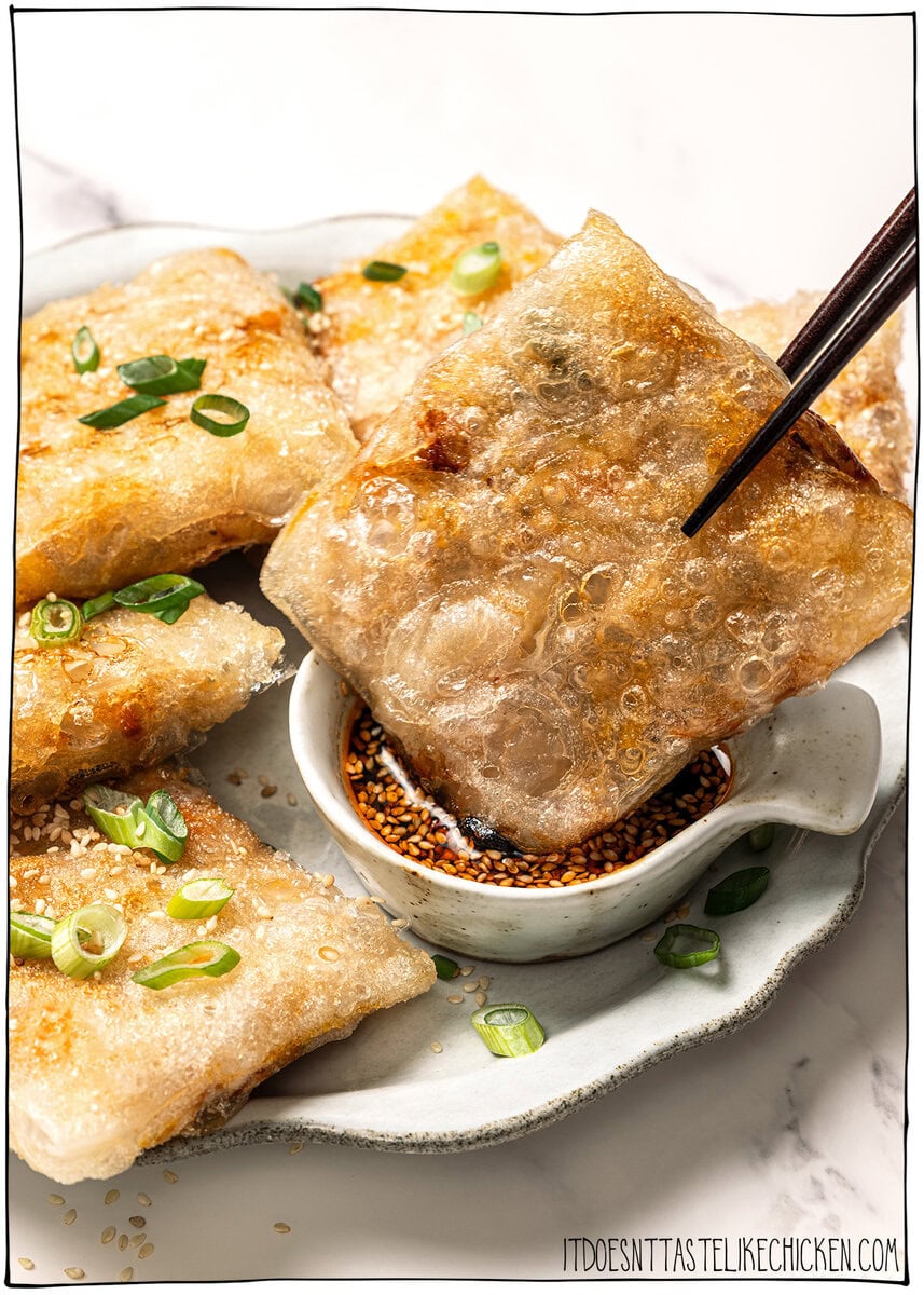 These vegan rice paper dumplings are crispy on the outside, chewy around the edges, with a savory cabbage and tofu filling. Viral on TikTok! Dipping rice paper dumpling into sauce.