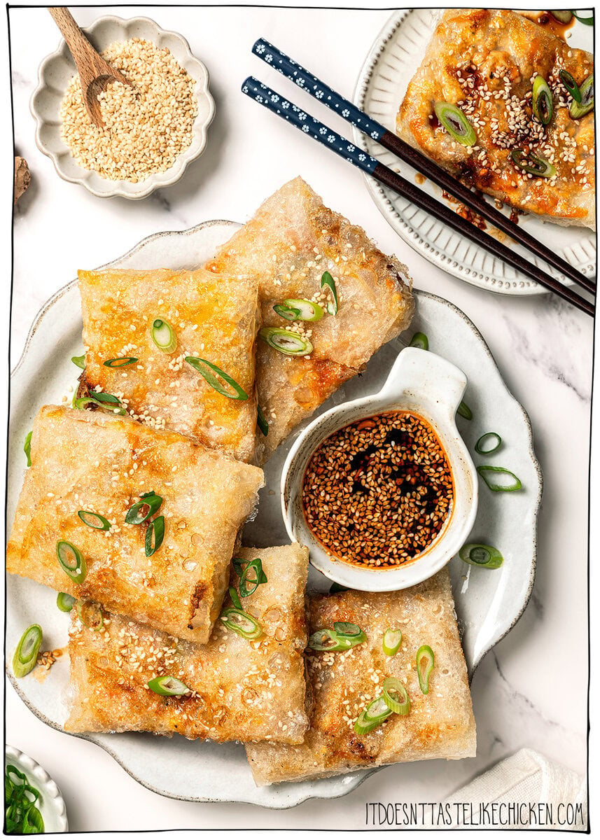These vegan rice paper dumplings are crispy on the outside, chewy around the edges, with a savory cabbage and tofu filling. Viral on TikTok! Two plates of rice paper dumplings.