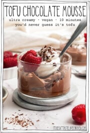 Bowl of mousse with whipped cream and raspberries, with text overlay that reads tofu chocolate mousse.