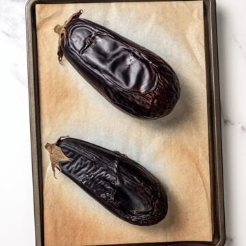 Eggplant on parchment-lined sheet pan.