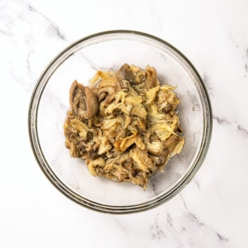 Roasted eggplant in glass bowl.
