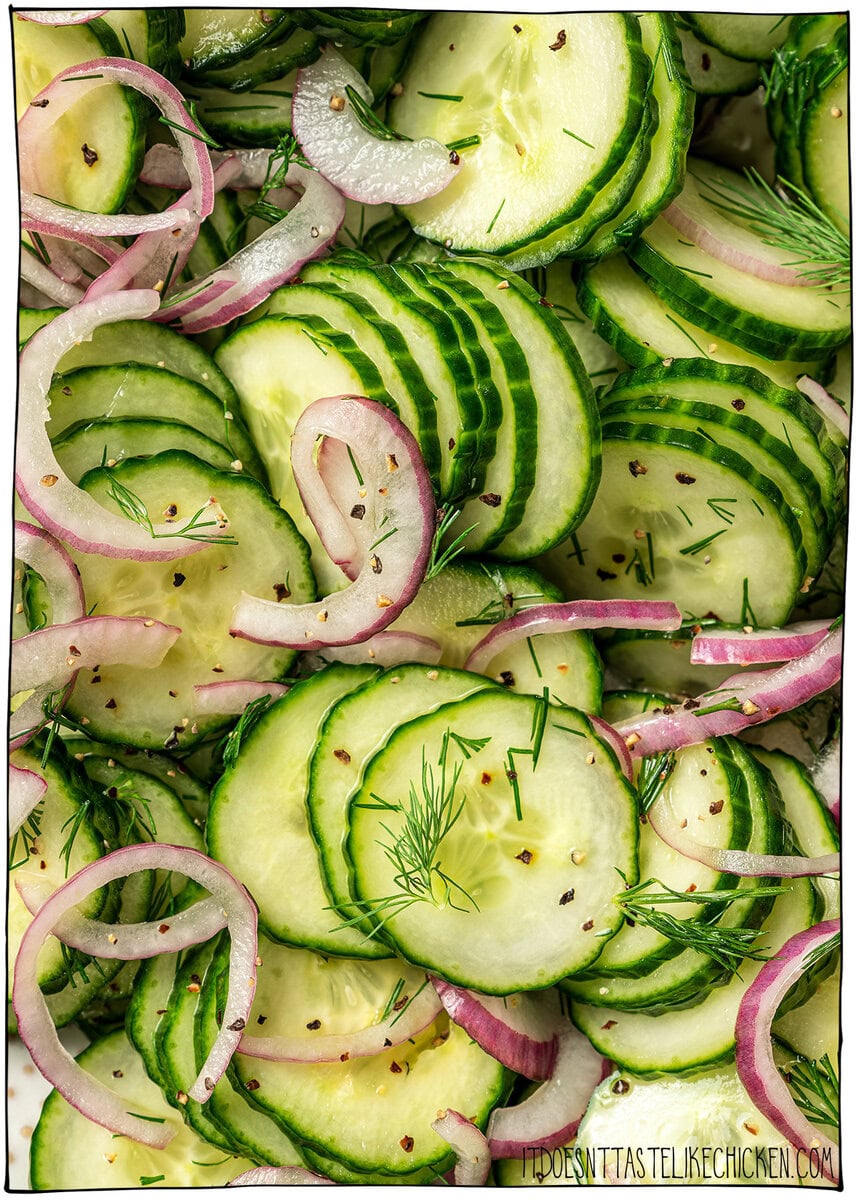 This easy cucumber dill salad is light, crisp, and refreshing, made with thinly sliced cucumbers, red onion, and a simple tangy vinaigrette. Closeup of cucumber dill salad.