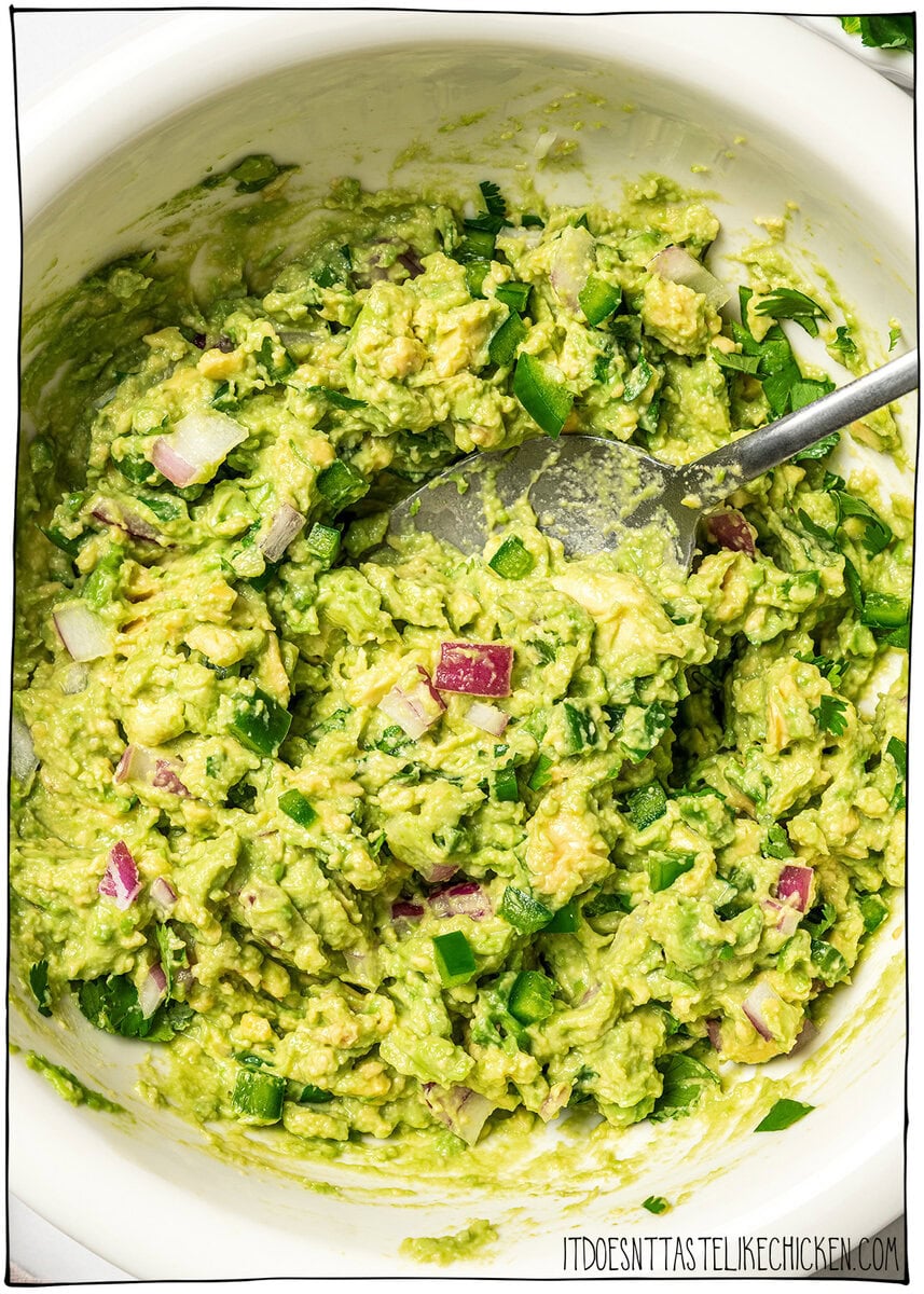 This easy Chipotle guacamole recipe is creamy, bright, and packed with fresh flavor, just like the restaurant version. Only 5 ingredients! Bowl of Chipotle guacamole with spoon.