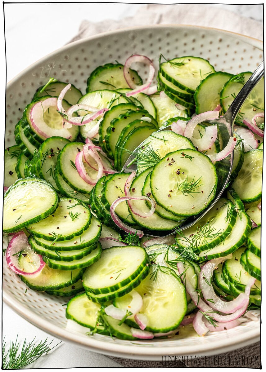 This easy cucumber dill salad is light, crisp, and refreshing, made with thinly sliced cucumbers, red onion, and a simple tangy vinaigrette. Spoonful of cucumber dill salad in bowl.