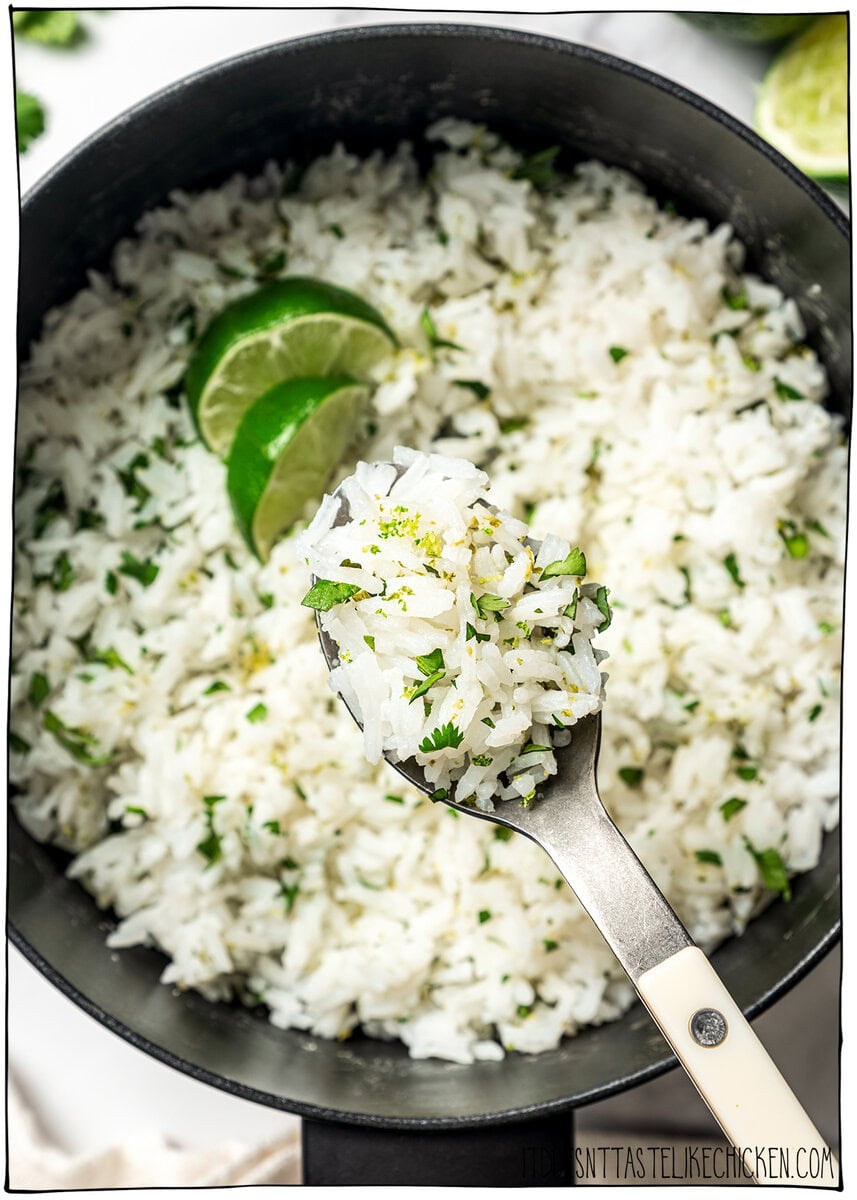 This easy Chipotle rice recipe is fluffy, lightly seasoned, and finished with fresh lime juice and cilantro for that signature fresh flavor! Forkful of cilantro lime rice.