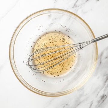 Whisk in bowl with vinaigrette.