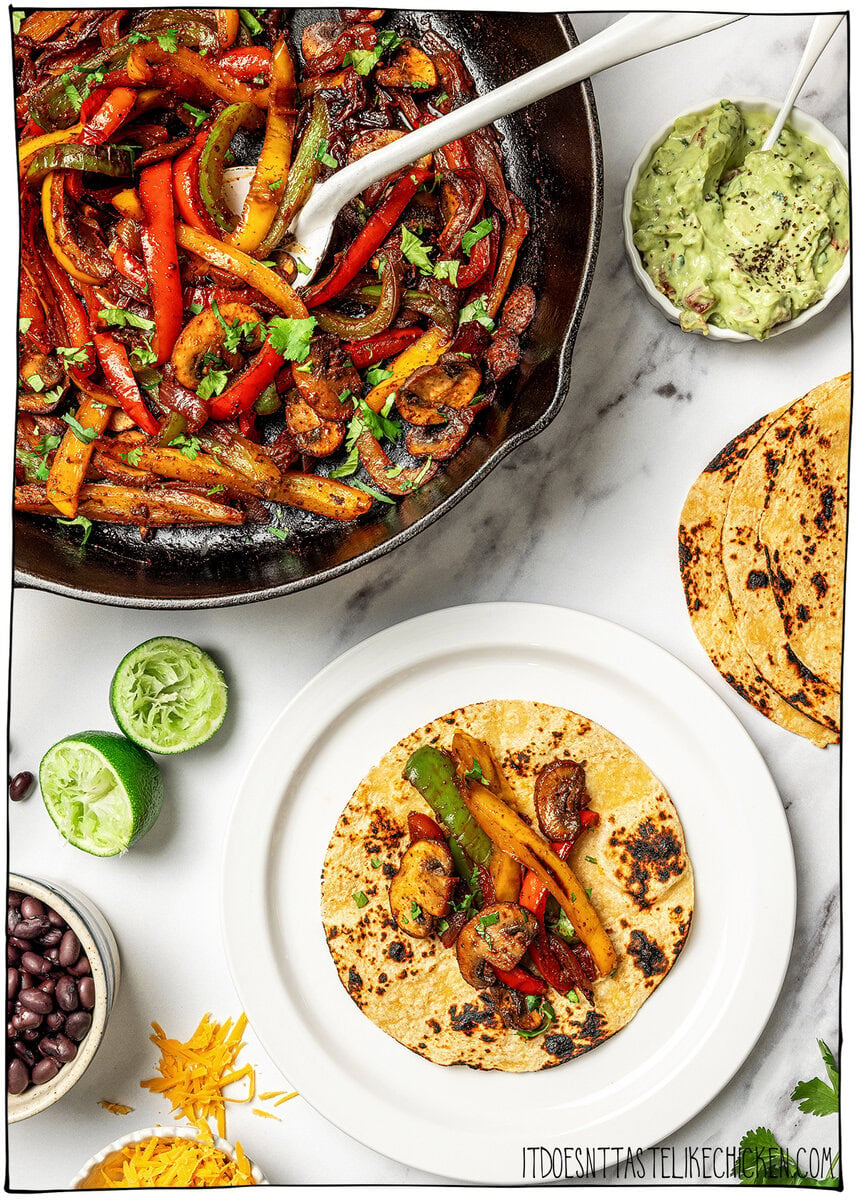 Fajita veggies in skillet and on charred tortilla.