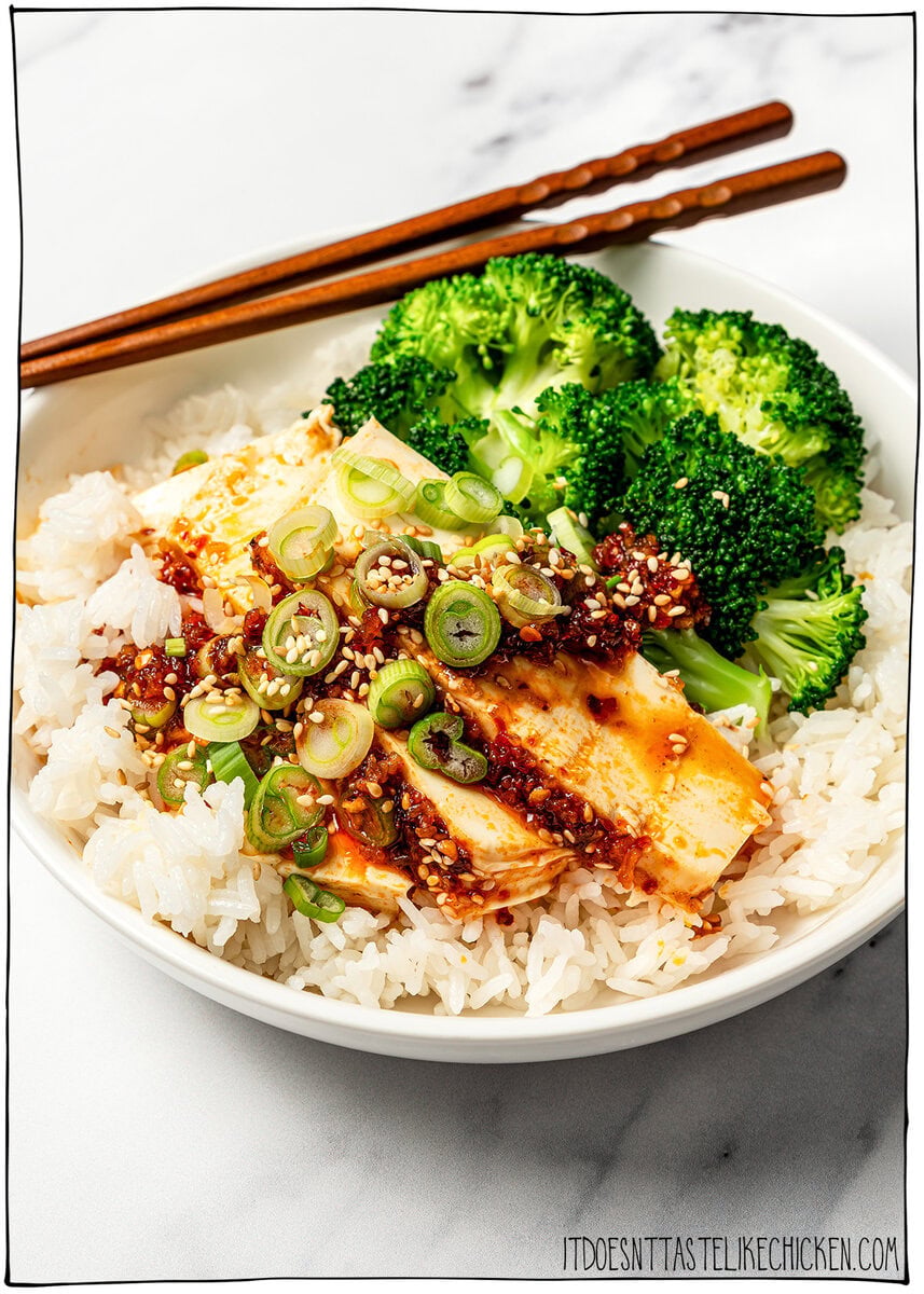 Bowl of rice with slices of chili crisp tofu and broccoli.