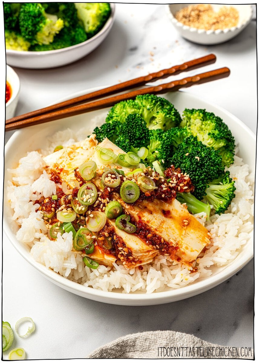 Bowl of rice with slices of chili crisp tofu and broccoli.