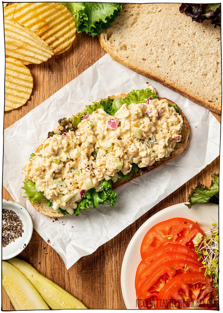 This chickpea salad sandwich is creamy, tangy and made with simple ingredients in just 10 minutes. Perfect for meal prep and quick lunches! Chickpea salad on slice of bread with lettuce.