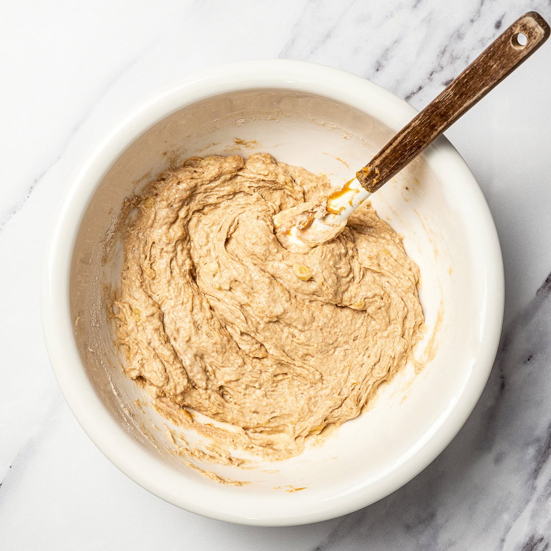 This easy dog birthday cake recipe is soft, simple and made with wholesome, dog-friendly ingredients like banana, oats and peanut butter! Bowl of dog birthday cake batter.