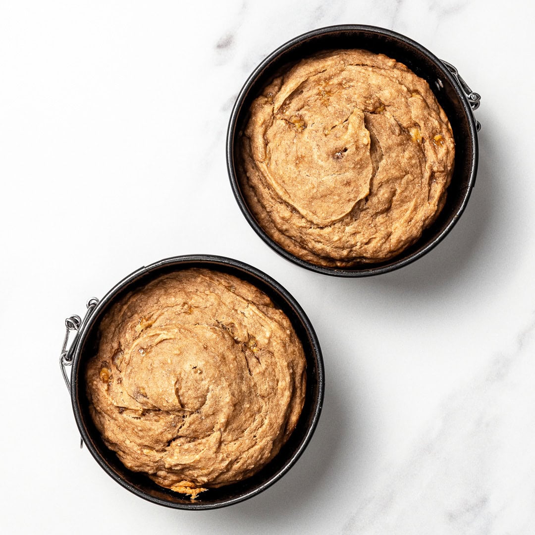 This easy dog birthday cake recipe is soft, simple and made with wholesome, dog-friendly ingredients like banana, oats and peanut butter! Two dog birthday cake layers in springform pans.
