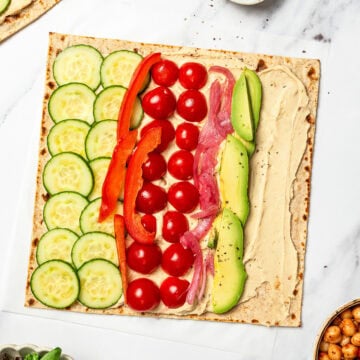 Veggies added to hummus wrap.