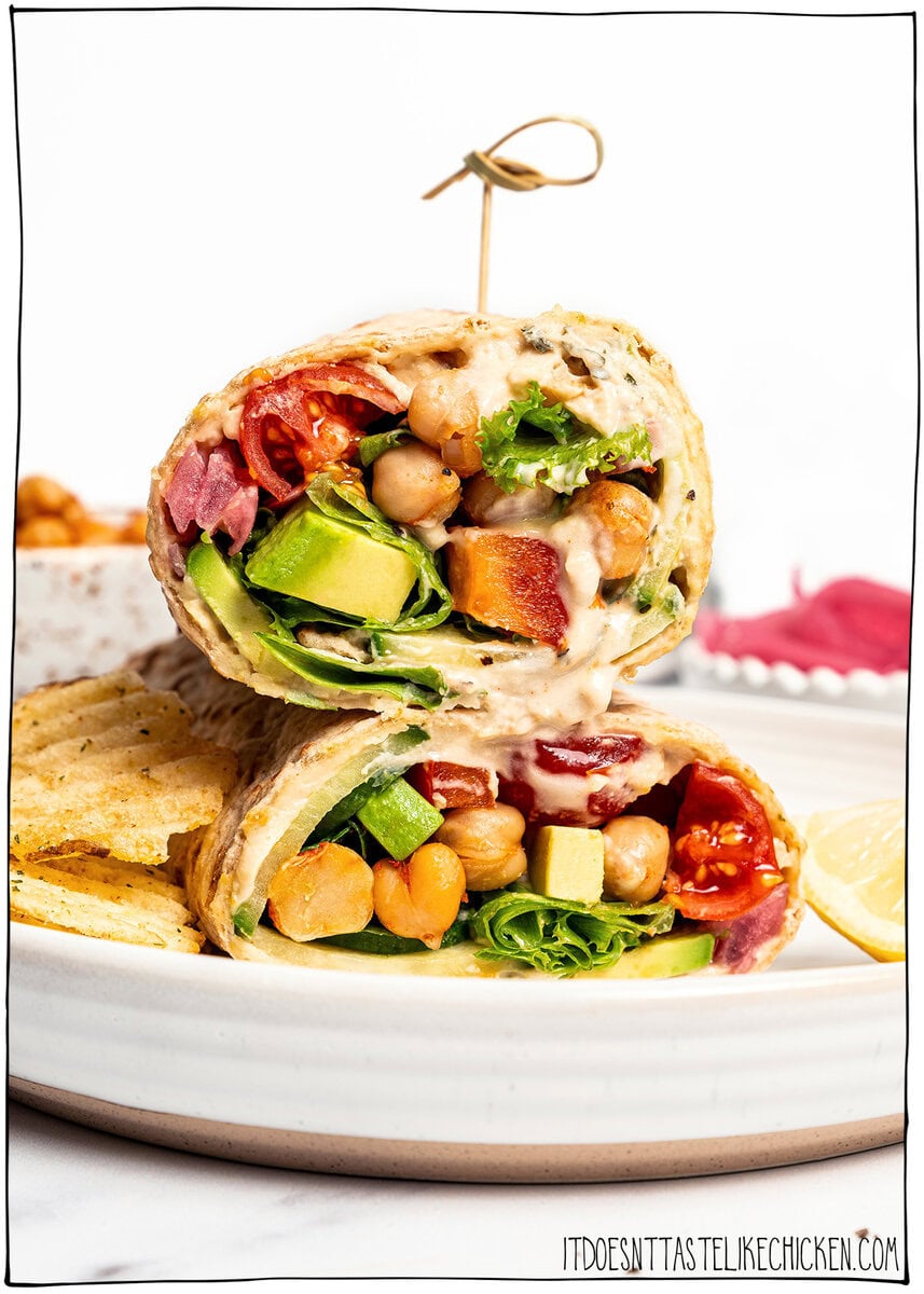 Made with simple ingredients in just 10 minutes, this crunchy hummus veggie wrap is perfect for lunch, meal prep, or an easy no-cook dinner! Veggie hummus wrap halves stacked on top of each other.