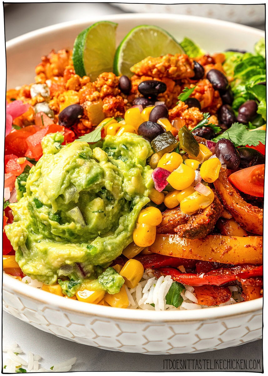 A guide to building your own burrito bowl with rice, protein, veggies, salsa, and creamy toppings for an easy and satisfying vegan meal. Burrito bowl with corn salsa, guacamole, black beans, and fajita veggies.