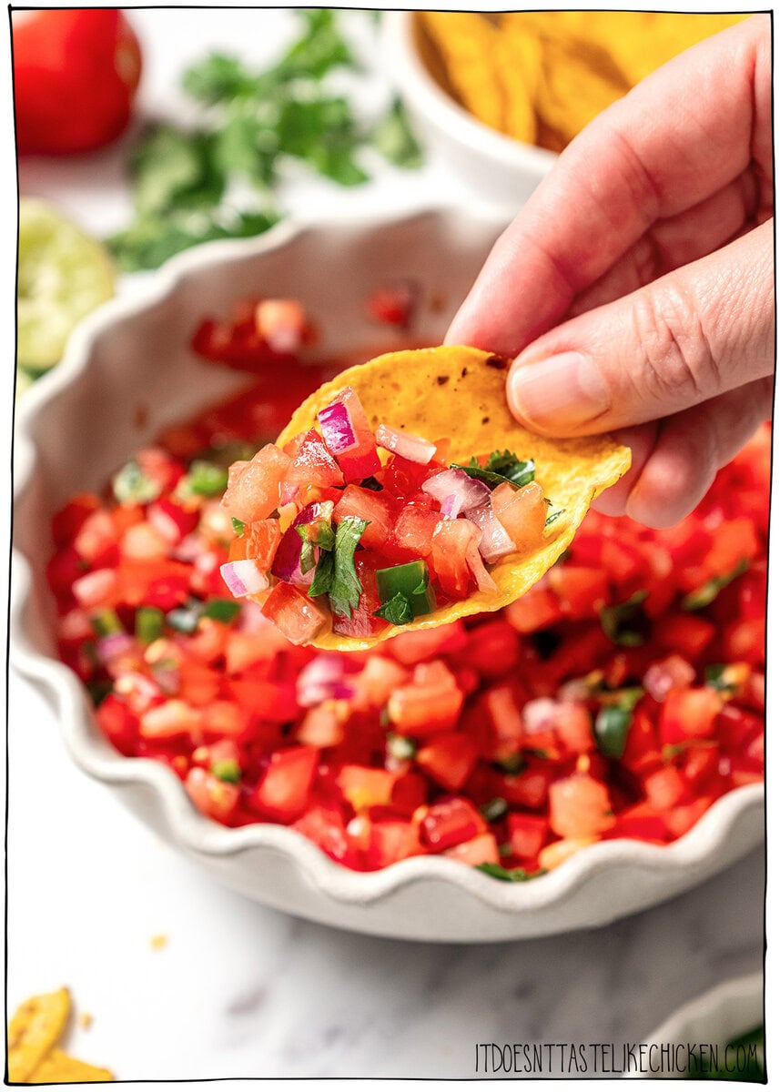 This pico de gallo tastes just like Chipotle's, but even better because it’s extra fresh, easy to customize, and made at home in minutes! Tortilla chip topped with pico de gallo.