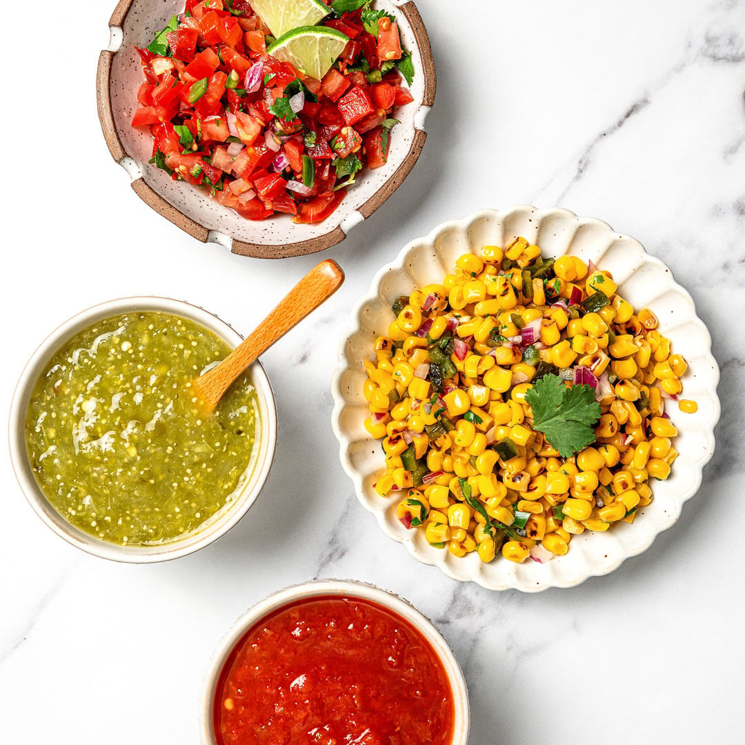 A guide to building your own burrito bowl with rice, protein, veggies, salsa, and creamy toppings for an easy and satisfying vegan meal.