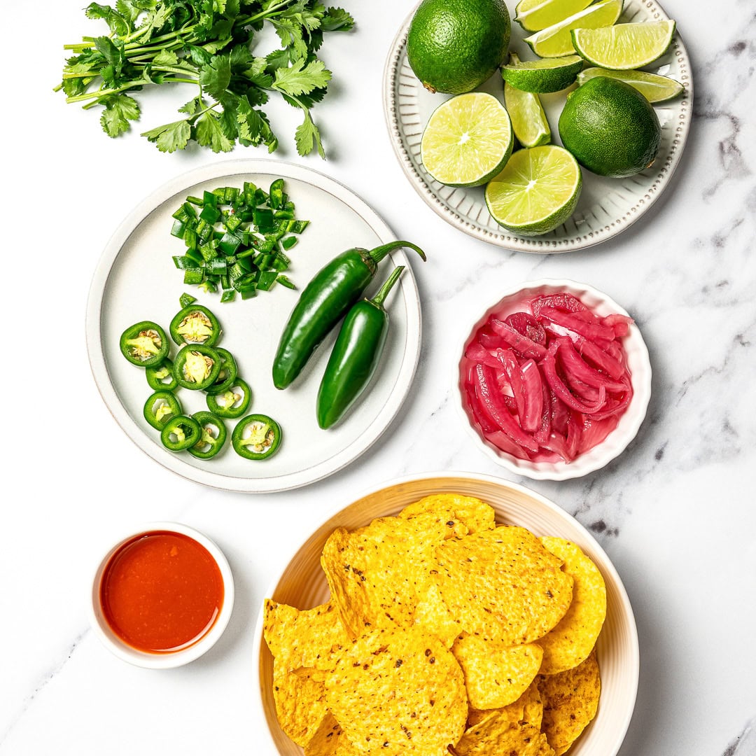 A guide to building your own burrito bowl with rice, protein, veggies, salsa, and creamy toppings for an easy and satisfying vegan meal.