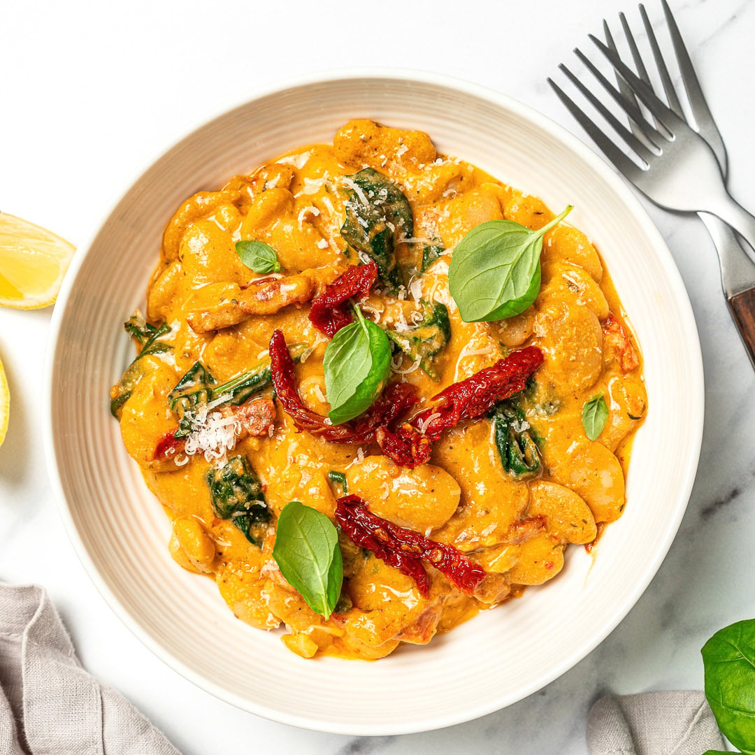 Marry me butter beans are an easy one-pan vegan dinner recipe with a creamy sun-dried tomato garlic sauce that tastes restaurant-worthy! Marry me butter beans in bowl.
