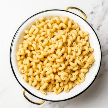Cooked pasta in colander.