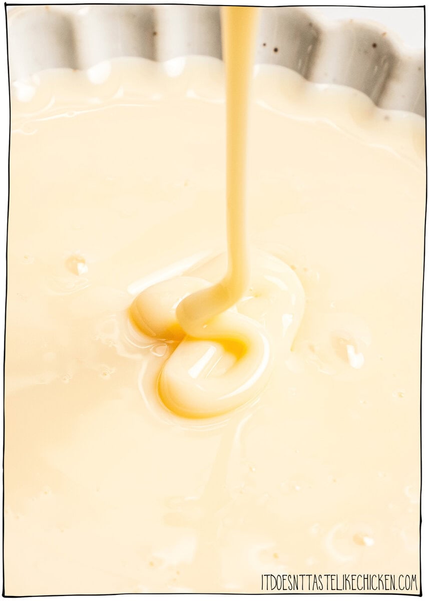 This easy vegan sweetened condensed milk is thick and creamy, perfect for using in dairy-free desserts and drinks. Just 2 ingredients! Vegan sweetened condensed milk being drizzled into bowl.